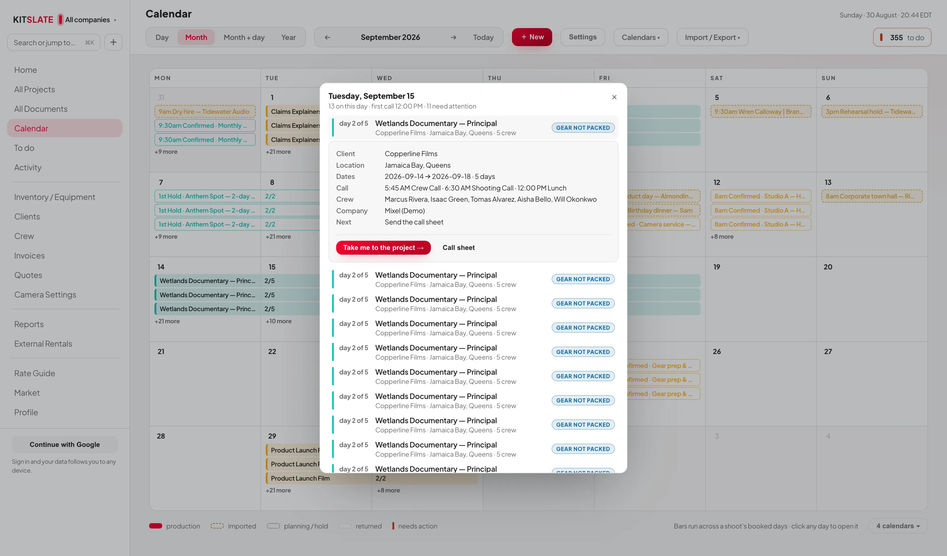 The calendar month view with a day card open in the centre of the screen, listing the day's bookings and one of them expanded to show client, location, dates, call times, crew, company and next action, with a Take me to the project button.
